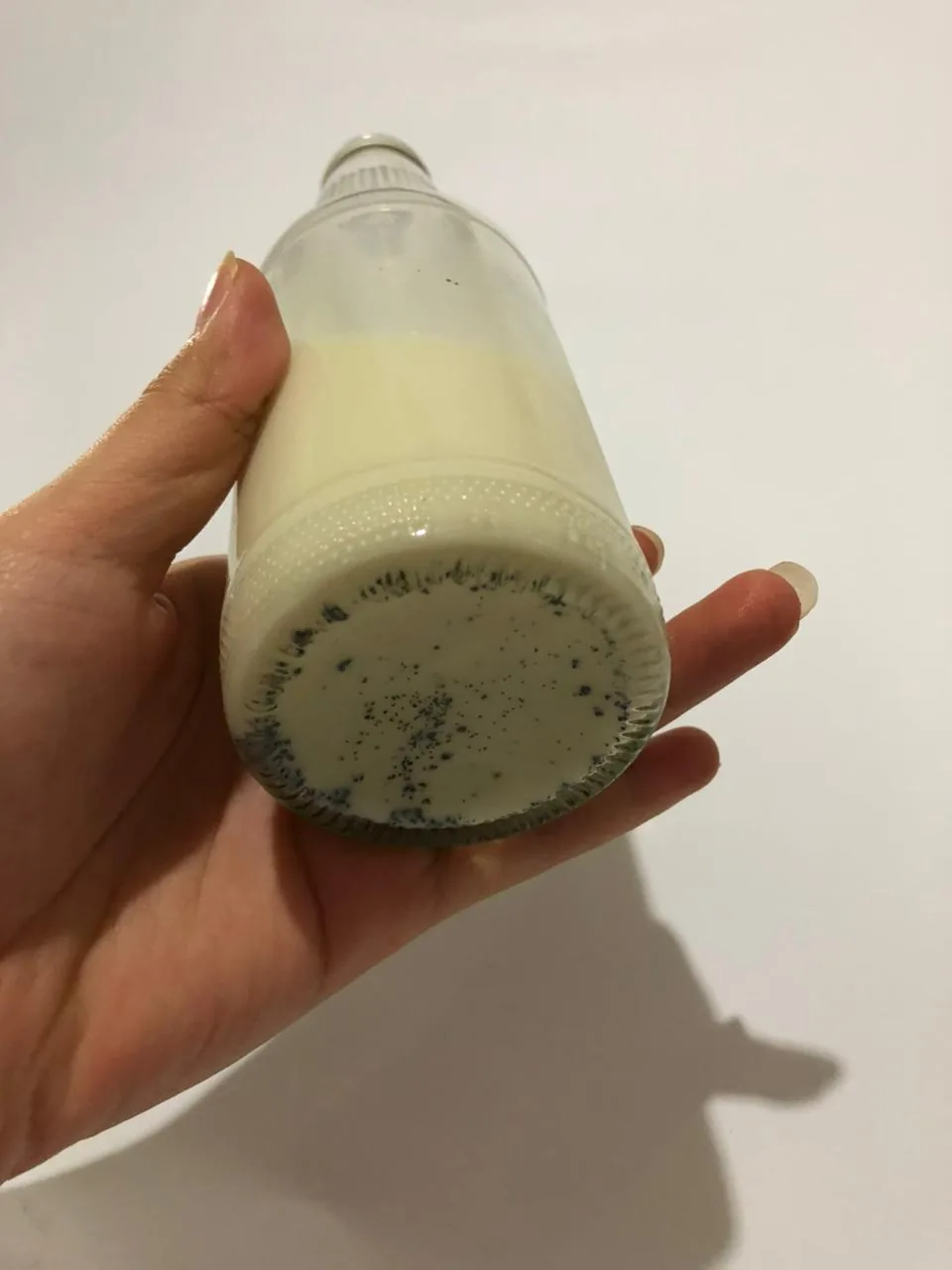 Vanilla seeds settled in a bottle of milk
